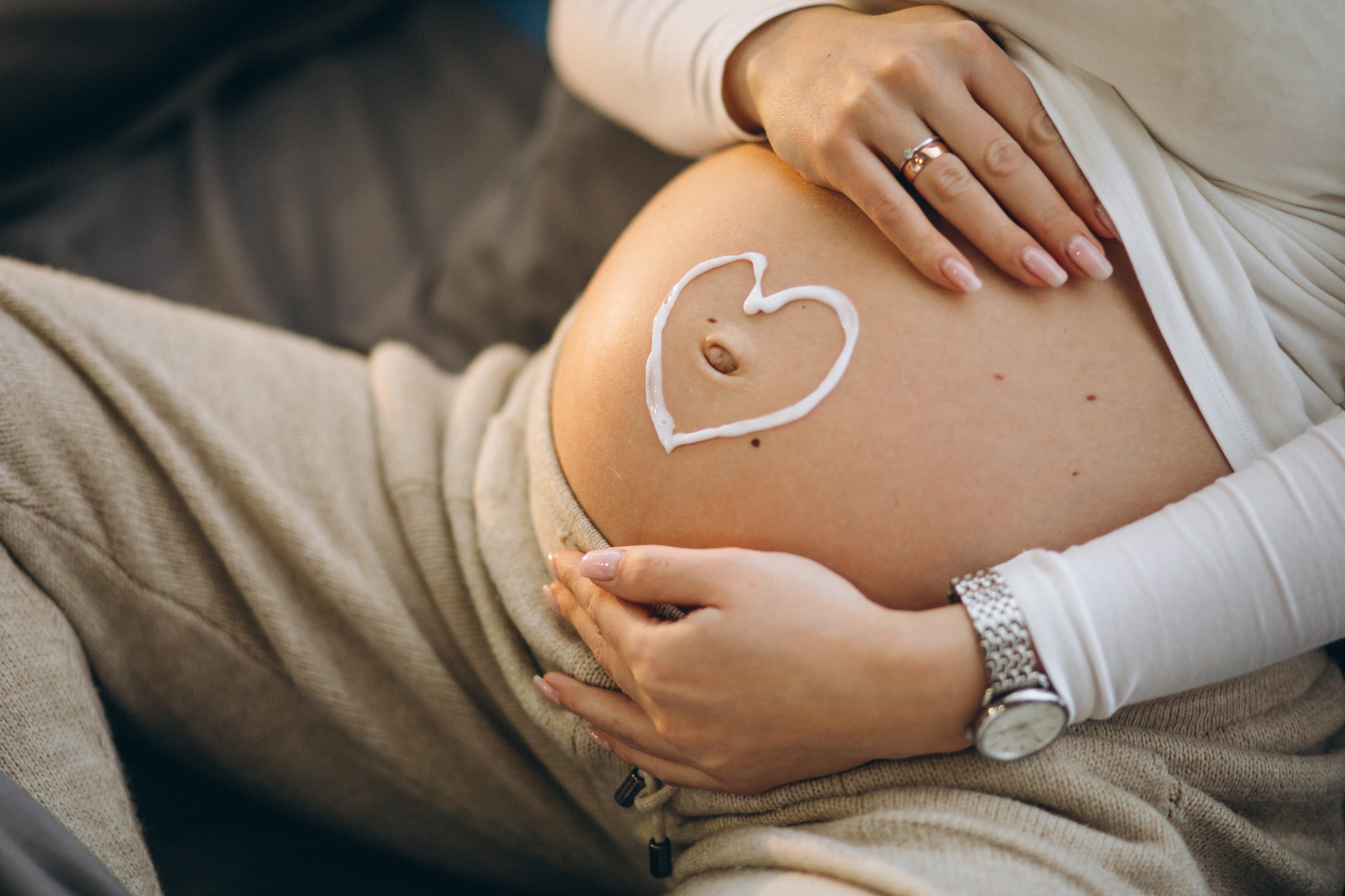 pregnant-woman-applying-cream-belly-prevent-stretches